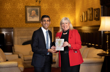 Amanda pictured with the Prime Minister Rishi Sunak and the winning Christmas card